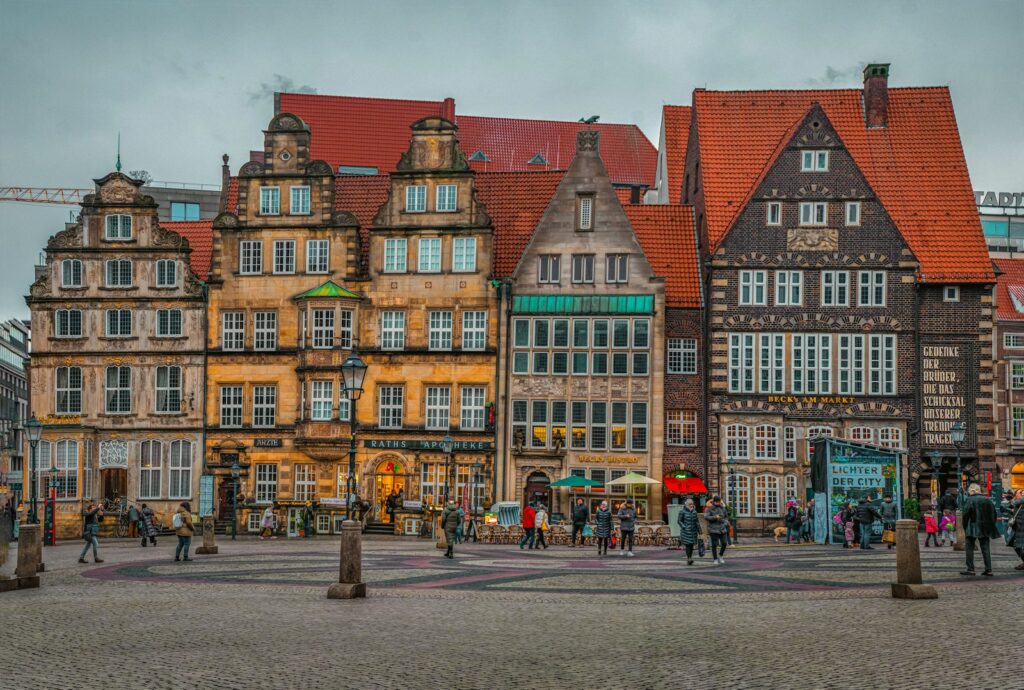 a group of people walking around a city square