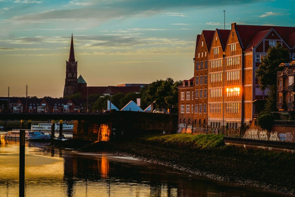 A view of a river with a bridge and buildings in the background